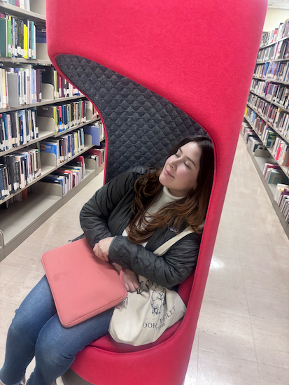 rebeca sitting at the library